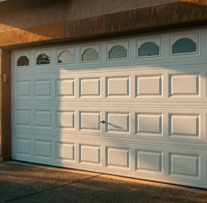 Raised-panel garage door with arched windows