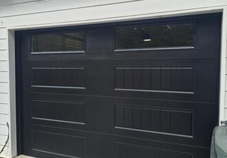 Black carriage-house garage door with windows