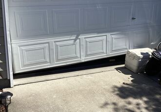 Damaged lower garage door sections in Northglenn