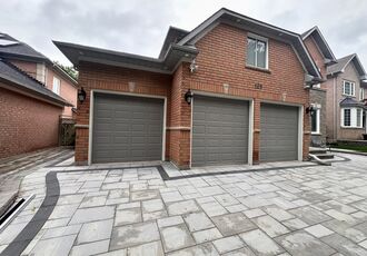 Front view of the new doors and paver driveway