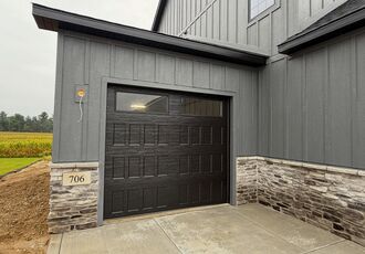 Single black garage door with windows