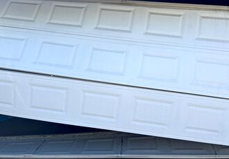 Bent garage door sections after the door came off track