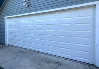 Repaired white double garage door, front view